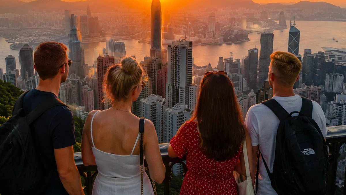 Visitors photographing the Hong Kong skyline from Sky Terrace 428 on Victoria Peak at blue hour during a photo tour
